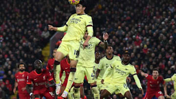 Arsenal's Japanese defender Takehiro Tomiyasu heads the ball clear during the English Premier League football match between Liverpool and Arsenal at Anfield in Liverpool, north west England on November 20, 2021. - - RESTRICTED TO EDITORIAL USE. No use with unauthorized audio, video, data, fixture lists, club/league logos or 'live' services. Online in-match use limited to 120 images. An additional 40 images may be used in extra time. No video emulation. Social media in-match use limited to 120 images. An additional 40 images may be used in extra time. No use in betting publications, games or single club/league/player publications. (Photo by Paul ELLIS / AFP) / RESTRICTED TO EDITORIAL USE. No use with unauthorized audio, video, data, fixture lists, club/league logos or 'live' services. Online in-match use limited to 120 images. An additional 40 images may be used in extra time. No video emulation. Social media in-match use limited to 120 images. An additional 40 images may be used in extra time. No use in betting publications, games or single club/league/player publications. / RESTRICTED TO EDITORIAL USE. No use with unauthorized audio, video, data, fixture lists, club/league logos or 'live' services. Online in-match use limited to 120 images. An additional 40 images may be used in extra time. No video emulation. Social media in-match use limited to 120 images. An additional 40 images may be used in extra time. No use in betting publications, games or single club/league/player publications. (Photo by PAUL ELLIS/AFP via Getty Images)