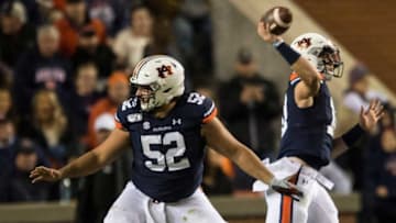 Auburn football offensive lineman Nick Brahms (52) protects quarterback Bo Nix (10) as he throws the ball at Jordan-Hare Stadium in Auburn, Ala., on Saturday, Nov. 2, 2019. Auburn defeated Ole Miss 20-14.