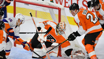 Sep 28, 2021; Philadelphia, Pennsylvania, USA; Philadelphia Flyers goaltender Samuel Ersson (33) covers the puck against the New York Islanders during the third period at Wells Fargo Center. Mandatory Credit: Eric Hartline-USA TODAY Sports