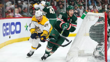 ST PAUL, MN - MARCH 13: Jared Spurgeon #46 of the Minnesota Wild and Tanner Jeannot #84 of the Nashville Predators compete for the puck in the first period of the game at Xcel Energy Center on March 13, 2022 in St Paul, Minnesota. (Photo by David Berding/Getty Images)