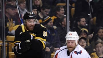 Mar 5, 2016; Boston, MA, USA; Washington Capitals left wing Jason Chimera (25) checks Boston Bruins right wing Jimmy Hayes (11) during the first period at TD Garden. Mandatory Credit: Bob DeChiara-USA TODAY Sports