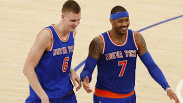 Mar 24, 2016; New York, NY, USA; New York Knicks forward Kristaps Porzingis (6) and forward Carmelo Anthony (7) laugh on the court during second half time out against the Chicago Bulls at Madison Square Garden. The Knicks won 106-94. Mandatory Credit: Noah K. Murray-USA TODAY Sports