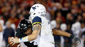 AMES, IA - OCTOBER 13: Defensive end JaQuan Bailey #3 of the Iowa State Cyclones sacks quarterback Will Grier #7 of the West Virginia Mountaineers as he scrambled for yards in the first half of play at Jack Trice Stadium on October 13, 2018 in Ames, Iowa. (Photo by David Purdy/Getty Images)