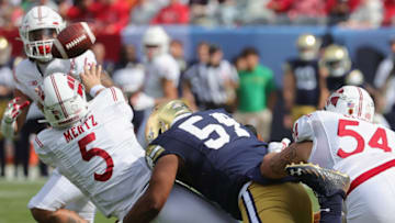CHICAGO, ILLINOIS - SEPTEMBER 25: Graham Mertz #5 of the Wisconsin Badgers tries to get off a pass as he's hit by Blake Fisher #54 of the Notre Dame Fighting Irish at Soldier Field on September 25, 2021 in Chicago, Illinois. (Photo by Jonathan Daniel/Getty Images)