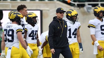 Michigan Wolverines head coach Jim Harbaugh watches his team warm-up before playing the Michigan State Spartans Saturday, Oct. 30, 2021.Msu Mich