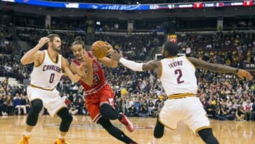 Oct 20, 2014; Columbus, OH, USA; Chicago Bulls center Joakim Noah (13) drives between Cleveland Cavaliers forward Kevin Love (0) and guard Kyrie Irving (2) at Value City Arena. Mandatory Credit: Greg Bartram-USA TODAY Sports
