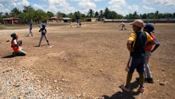 Children play baseball in the streets of "Boca Chica", Santo Domingo, on March 25, 2013. Dominican Republic, which won the third World Baseball Classic, is a territory where the "sport king" is taught in every corner and where major league organizations have the largest pool of prospects outside the United States. AFP PHOTO/ERIKA SANTELICES (Photo credit should read ERIKA SANTELICES/AFP via Getty Images)