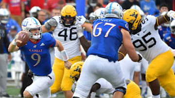 LAWRENCE, KANSAS - SEPTEMBER 21: Carter Stanley #9 of the Kansas Jayhawks scrambles out of the pocket as he looks for an open receiver against the West Virginia Mountaineers second quarter at Memorial Stadium on September 21, 2019 in Lawrence, Kansas. (Photo by Ed Zurga/Getty Images)