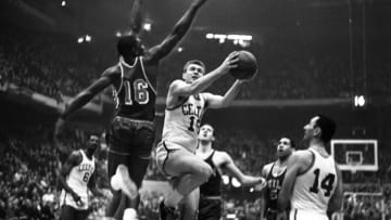 Tommy Heinsohn of the Celtic's, breaks past Al Attles of the Warriors, #16, to lay-up for a basket in the 1st quarter playoff.