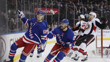 NEW YORK, NEW YORK - APRIL 03: Lias Andersson #50 of the New York Rangers (l) scores a short-handed goal at 4:52 of the second period against the Ottawa Senators and is joined by Brendan Smith #42 (r) at Madison Square Garden on April 03, 2019 in New York City. (Photo by Bruce Bennett/Getty Images)