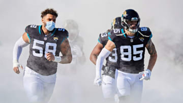 JACKSONVILLE, FLORIDA - DECEMBER 27: Eric Saubert #85 and Doug Costin #58 of the Jacksonville Jaguars enter the field before the start of a game against the Chicago Bears at TIAA Bank Field on December 27, 2020 in Jacksonville, Florida. (Photo by James Gilbert/Getty Images)