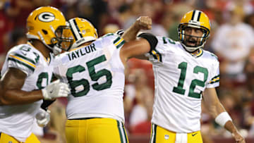 LANDOVER, MD - AUGUST 19: Quarterback Aaron Rodgers #12 of the Green Bay Packers celebrates a touchdown pass with teammate Lane Taylor #65 against the Washington Redskins in the first half during a preseason game at FedExField on August 19, 2017 in Landover, Maryland. (Photo by Patrick Smith/Getty Images)