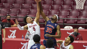 Mar 2, 2021; Tuscaloosa, Alabama, USA; Alabama Crimson Tide guard Jaden Shackelford (5) and Auburn basketball guard Devan Cambridge (35) go for a rebound during the first half at Coleman Coliseum. Mandatory Credit: Marvin Gentry-USA TODAY Sports