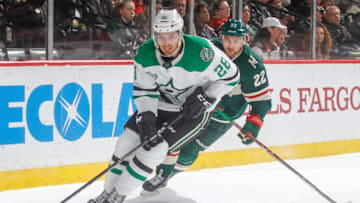 ST. PAUL, MN - MARCH 29: Stephen Johns #28 of the Dallas Stars skates with the puck while Nino Niederreiter #22 of the Minnesota Wild defends during the game at the Xcel Energy Center on March 29, 2018 in St. Paul, Minnesota. (Photo by Bruce Kluckhohn/NHLI via Getty Images)