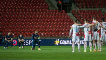 Arsenal's Alexandre Lacazette (C) and his team mates take a knee in support of the Black Lives Matter movement prior to the UEFA Europa League quarter-final second leg football match between Slavia Prague and Arsenal in Prague on April 15, 2021. (Photo by Michal Cizek / AFP) (Photo by MICHAL CIZEK/AFP via Getty Images)