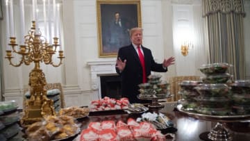 US President Donald Trump speaks alongside fast food he purchased for a ceremony honoring the 2018 College Football Playoff National Champion Clemson Tigers in the State Dining Room of the White House in Washington, DC, January 14, 2019. - Trump says the White House chefs are furloughed due to the partial government shutdown. (Photo by SAUL LOEB / AFP) (Photo credit should read SAUL LOEB/AFP/Getty Images)
