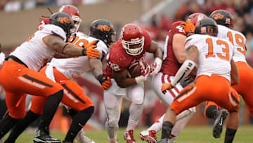 Dec 6, 2014; Norman, OK, USA; Oklahoma Sooners running back Samaje Perine (32) runs the ball against Oklahoma State Cowboys safety Jordan Sterns (13) during the first quarter at Gaylord Family - Oklahoma Memorial Stadium. Mandatory Credit: Mark D. Smith-USA TODAY Sports