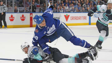 TORONTO, CANADA - NOVEMBER 30: Kailer Yamamoto #56 of the Seattle Kraken collides with William Nylander #88 of the Toronto Maple Leafs during the third period in an NHL game at Scotiabank Arena on November 30, 2023 in Toronto, Ontario, Canada. The Maple Leafs defeated the Kraken 4-3 in a shootout. (Photo by Claus Andersen/Getty Images)