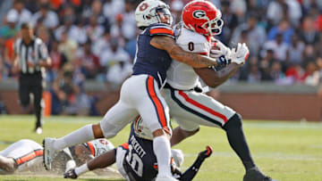 Auburn footballOct 9, 2021; Auburn, Alabama, USA; Georgia Bulldogs tight end Darnell Washington (0) is tackled by Auburn Tigers safety Zion Puckett (10) and Auburn Tigers safety Donovan Kaufman (1) during the second quarter at Jordan-Hare Stadium. Mandatory Credit: John Reed-USA TODAY Sports