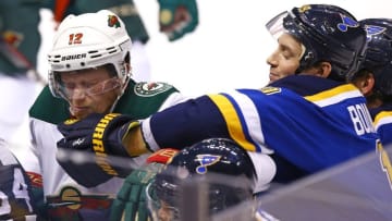 Oct 13, 2016; St. Louis, MO, USA; St. Louis Blues defenseman Jay Bouwmeester (19) lands a punch to the chin of Minnesota Wild center Eric Staal (12) during the third period at Scottrade Center. The Blues won the game 3-2. Mandatory Credit: Billy Hurst-USA TODAY Sports