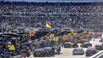 Apr 2, 2016; Martinsville, VA, USA; NASCAR Sprint Cup Series cars make an early pit stop during the Alpha Energy Solutions 250 at Martinsville Speedway. Mandatory Credit: Michael Shroyer-USA TODAY Sports