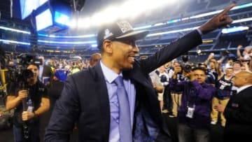 Apr 7, 2014; Arlington, TX, USA; Connecticut Huskies head coach Kevin Ollie gestures to fans after defeating the Kentucky Wildcats in the championship game of the Final Four in the 2014 NCAA Mens Division I Championship tournament at AT&T Stadium. Mandatory Credit: Bob Donnan-USA TODAY Sports