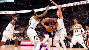 DENVER, CO - MARCH 12: Karl-Anthony Towns #32 of the Minnesota Timberwolves drives against Nikola Jokic #15 of the Denver Nuggets. (Photo by Jamie Schwaberow/Getty Images)