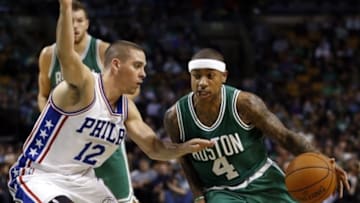 Oct 28, 2015; Boston, MA, USA; Boston Celtics point guard Isaiah Thomas (4) drives to the basket while defended by Philadelphia 76ers point guard T.J. McConnell (12) during the second half at TD Garden. The Boston Celtics won 112-95. Mandatory Credit: Greg M. Cooper-USA TODAY Sports