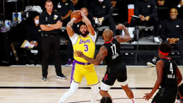 LAKE BUENA VISTA, FLORIDA - AUGUST 06: Anthony Davis #3 of the Los Angeles Lakers controls the ball while defended by P.J. Tucker #17 of the Houston Rockets in the first half at The Arena at ESPN Wide World Of Sports Complex on August 6, 2020 in Lake Buena Vista, Florida. NOTE TO USER: User expressly acknowledges and agrees that, by downloading and or using this photograph, User is consenting to the terms and conditions of the Getty Images License Agreement. (Photo by Kim Klement-Pool/Getty Images)