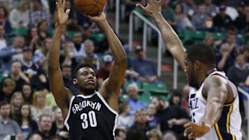 Feb 27, 2016; Salt Lake City, UT, USA; Brooklyn Nets forward Thaddeus Young (30) takes a three-pointer in the third quarter against Utah Jazz forward Derrick Favors (15) at Vivint Smart Home Arena. The Brooklyn Nets defeated the Utah Jazz 98-96. Mandatory Credit: Jeff Swinger-USA TODAY Sports
