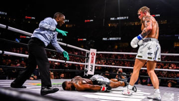 YouTube personality Jake Paul (R) knocks out Tyron Woodley in an eight-round cruiserweight bout at the Amalie Arena in Tampa, Florida, on December 18, 2021. (Photo by CHANDAN KHANNA / AFP) (Photo by CHANDAN KHANNA/AFP via Getty Images)