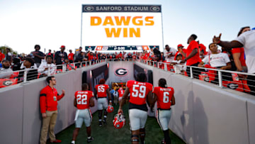 ATHENS, GA - OCTOBER 08: Branson Robinson #22, Broderick Jones #59 and Kenny McIntosh #6 of the Georgia Bulldogs head to the tunnel at the conclusion of the game against the Auburn Tigers at Sanford Stadium on October 8, 2022 in Athens, Georgia. (Photo by Todd Kirkland/Getty Images)