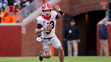 KNOXVILLE, TENNESSEE - NOVEMBER 13: Stetson Bennett #13 of the Georgia Bulldogs runs with the ball in the first quarter against the Tennessee Volunteers at Neyland Stadium on November 13, 2021 in Knoxville, Tennessee. (Photo by Dylan Buell/Getty Images)