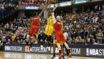 Apr 14, 2015; Indianapolis, IN, USA; Indiana Pacers forward Paul George (13) misses a game winning three pointer at the end of the first overtime against Washington Wizards center Marcin Gortat (4) and forward Rasual Butler (8) at Bankers Life Fieldhouse. Indiana defeats Washington 99-95 in double overtime. Mandatory Credit: Brian Spurlock-USA TODAY Sports