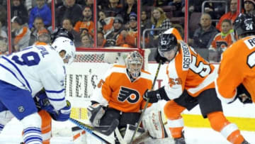 Jan 19, 2016; Philadelphia, PA, USA; Philadelphia Flyers defenseman Shayne Gostisbehere (53) clears the puck form in front of goalie Steve Mason (35) during the first period at Wells Fargo Center. Mandatory Credit: Eric Hartline-USA TODAY Sports