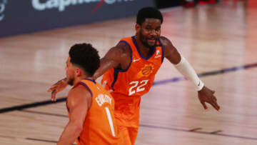 LAKE BUENA VISTA, FLORIDA - JULY 31: Deandre Ayton #22 of the Phoenix Suns is congratulated by Devin Booker #1 after making a three-point basket against the Washington Wizards in the second half of an NBA basketball game at ESPN Wide World Of Sports Complex on July 31, 2020 in Lake Buena Vista, Florida. NOTE TO USER: User expressly acknowledges and agrees that, by downloading and or using this photograph, User is consenting to the terms and conditions of the Getty Images License Agreement. (Photo by Kim Klement - Pool/Getty Images)