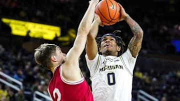 Michigan guard Dug McDaniel makes a jump shot against Indiana guard Gabe Cupps during the first half at Crisler Center in Ann Arbor on Tuesday, Dec. 5, 2023.