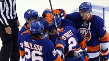 May 7, 2013; Uniondale, NY, USA; New York Islanders defenseman Mark Streit (2) celebrates his goal with teammates during the second period against the Pittsburgh Penguins in game four of the first round of the 2013 Stanley Cup playoffs at Nassau Veterans Memorial Coliseum. Mandatory Credit: Anthony Gruppuso-USA TODAY Sports