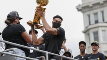 Jul 22, 2021; Milwaukee, WI, USA; Milwaukee Bucks forward Giannis Antetokounmpo (34) holds the Larry O'Brien NBA Championship Trophy during the Milwaukee Bucks victory parade. Mandatory Credit: Kamil Krzaczynski-USA TODAY Sports