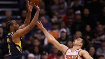 PHOENIX, ARIZONA - JANUARY 22: T.J. Warren #1 of the Indiana Pacers attempts a shot over Dario Saric #20 of the Phoenix Suns during the second half of the NBA game at Talking Stick Resort Arena on January 22, 2020 in Phoenix, Arizona. NOTE TO USER: User expressly acknowledges and agrees that, by downloading and or using this photograph, user is consenting to the terms and conditions of the Getty Images License Agreement. Mandatory Copyright Notice: Copyright 2020 NBAE. (Photo by Christian Petersen/Getty Images)