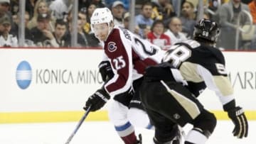 Nov 19, 2015; Pittsburgh, PA, USA; Colorado Avalanche center Mikhail Grigorenko (25) skates with the puck in front of Pittsburgh Penguins defenseman Kris Letang (58) during the third period at the CONSOL Energy Center. The Penguins won 4-3. Mandatory Credit: Charles LeClaire-USA TODAY Sports