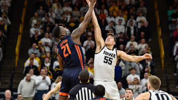 Feb 2, 2020; Iowa City, Iowa, USA; Illinois Fighting Illini center Kofi Cockburn (21) and Iowa Hawkeyes center Luka Garza (55) battle for the opening tipoff during the first half at Carver-Hawkeye Arena. Mandatory Credit: Jeffrey Becker-USA TODAY Sports