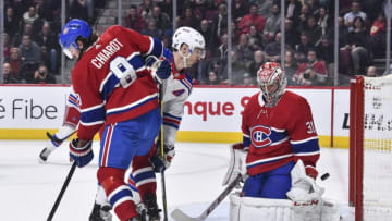 MONTREAL, QC - FEBRUARY 27: Ben Chiarot #8 of the Montreal Canadiens and Chris Kreider #20 of the New York Rangers battle for position as the puck passes goaltender Carey Price #31 during the third period at the Bell Centre on February 27, 2020 in Montreal, Canada. The New York Rangers defeated the Montreal Canadiens 5-2. (Photo by Minas Panagiotakis/Getty Images)