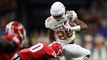 NEW ORLEANS, LOUISIANA - JANUARY 01: Keaontay Ingram #26 of the Texas Longhorns avoids a tackle by J.R. Reed #20 of the Georgia Bulldogs during the Allstate Sugar Bowl at Mercedes-Benz Superdome on January 01, 2019 in New Orleans, Louisiana. (Photo by Chris Graythen/Getty Images)