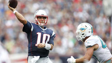 Sep 18, 2016; Foxborough, MA, USA; New England Patriots quarterback Jimmy Garoppolo (10) makes a pass while being defended by Miami Dolphins linebacker Kiko Alonso (47) during the second quarter at Gillette Stadium. Mandatory Credit: Greg M. Cooper-USA TODAY Sports