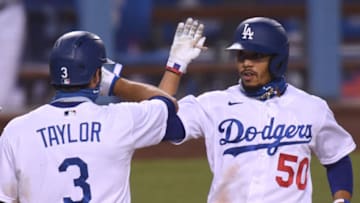 LOS ANGELES, CALIFORNIA - AUGUST 13: Mookie Betts #50 of the Los Angeles Dodgers celebrates his two run homerun with Chris Taylor #3, his third of the evening, to take an 11-2 lead over the San Diego Padres, during the fifth inning at Dodger Stadium on August 13, 2020 in Los Angeles, California. (Photo by Harry How/Getty Images)