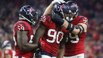 Dec 13, 2015; Houston, TX, USA; Houston Texans outside linebacker Jadeveon Clowney (90) celebrates with defensive end J.J. Watt (99) after sacking New England Patriots quarterback Tom Brady (not pictured) during the game at NRG Stadium. Mandatory Credit: Kevin Jairaj-USA TODAY Sports