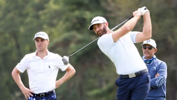 MAMARONECK, NEW YORK - SEPTEMBER 16: Dustin Johnson of the United States plays a shot as Justin Thomas of the United States and Claude Harmon III looks on during a practice round prior to the 120th U.S. Open Championship on September 16, 2020 at Winged Foot Golf Club in Mamaroneck, New York. (Photo by Jamie Squire/Getty Images)