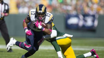 Oct 11, 2015; Green Bay, WI, USA; St. Louis Rams wide receiver Stedman Bailey (12) rushes with the football as Green Bay Packers safety Micah Hyde (33) defends during the second quarter at Lambeau Field. Mandatory Credit: Jeff Hanisch-USA TODAY Sports