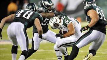 Aug 29, 2013; East Rutherford, NJ, USA; Philadelphia Eagles linebacker Emmanuel Acho (53) tackles New York Jets running back John Griffin (24) during the second half of a preseason game at Metlife Stadium. The Jets won 27-20. Mandatory Credit: Joe Camporeale-USA TODAY Sports
